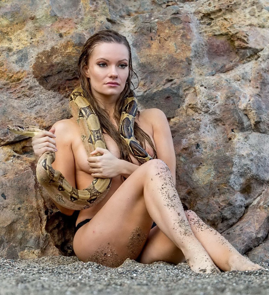 Caitlin O'Connor Holding A Giant Snake 10